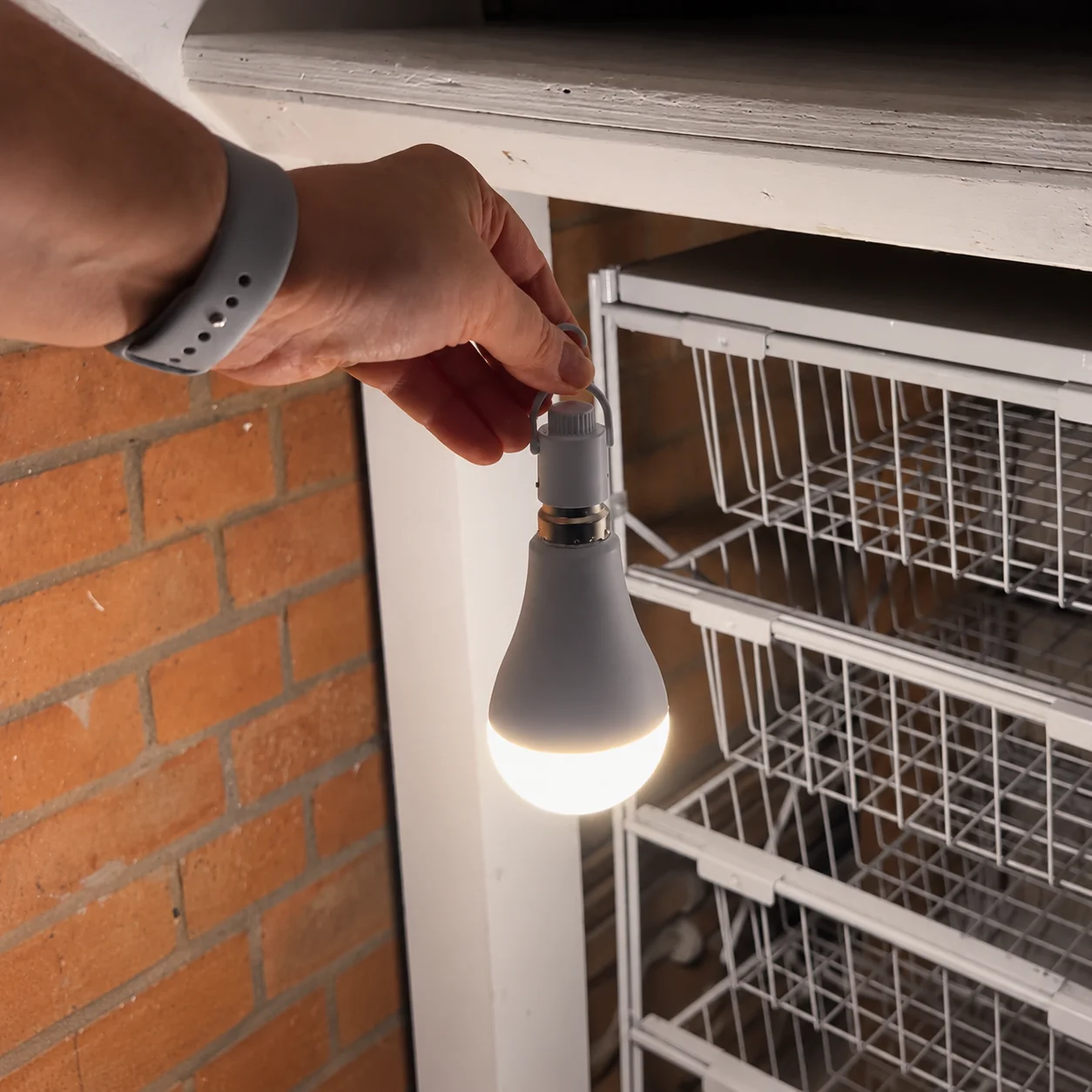 GSEL illuminated bulb suspended by its supplied hanging hook to light a utility cupboard